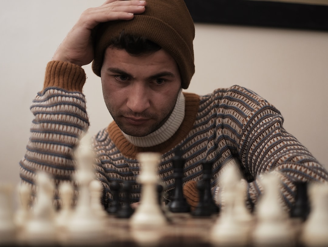 A man sitting at a table with a chess board