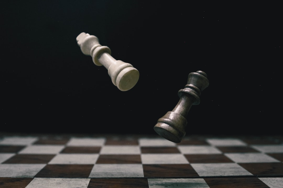 Échecs — a black and white checkered chess board with a white pawn