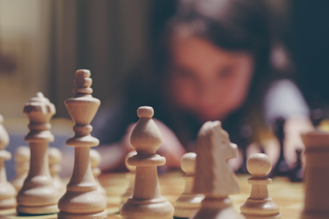 Brown wooden chess piece on brown wooden chess piece