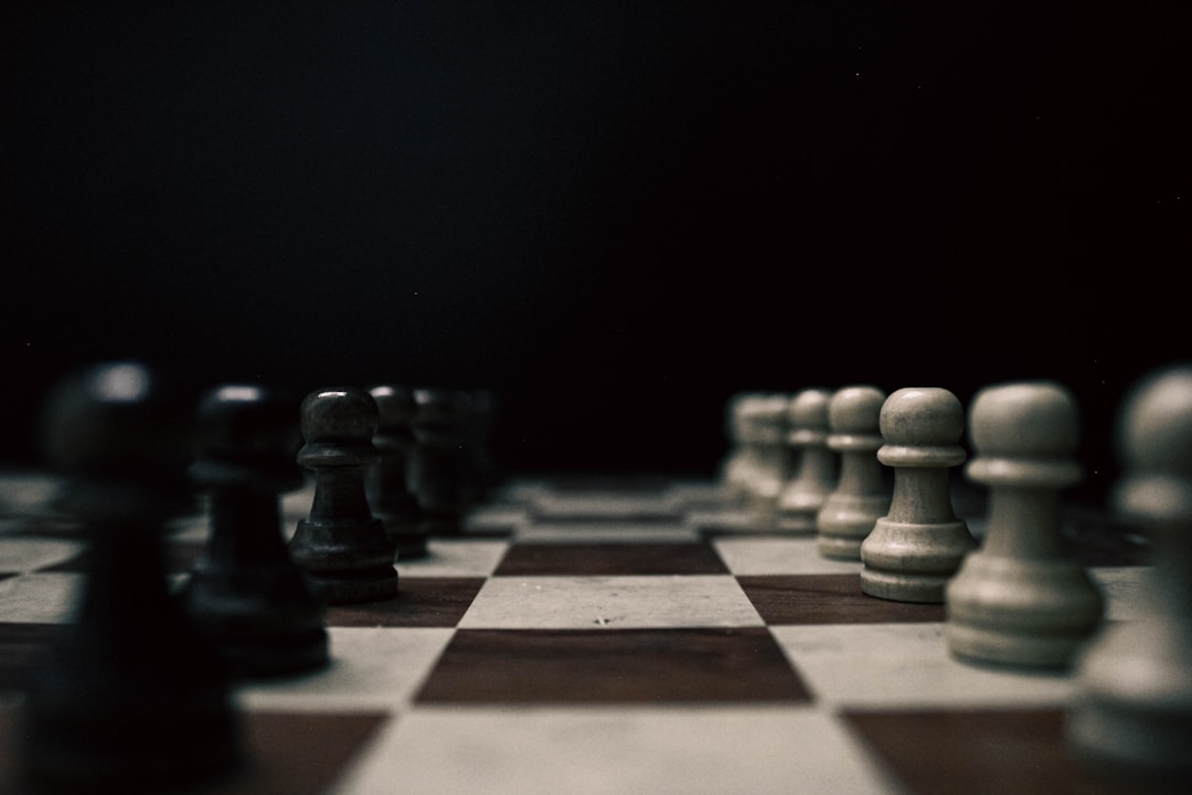 A black and white chess board with pieces on it