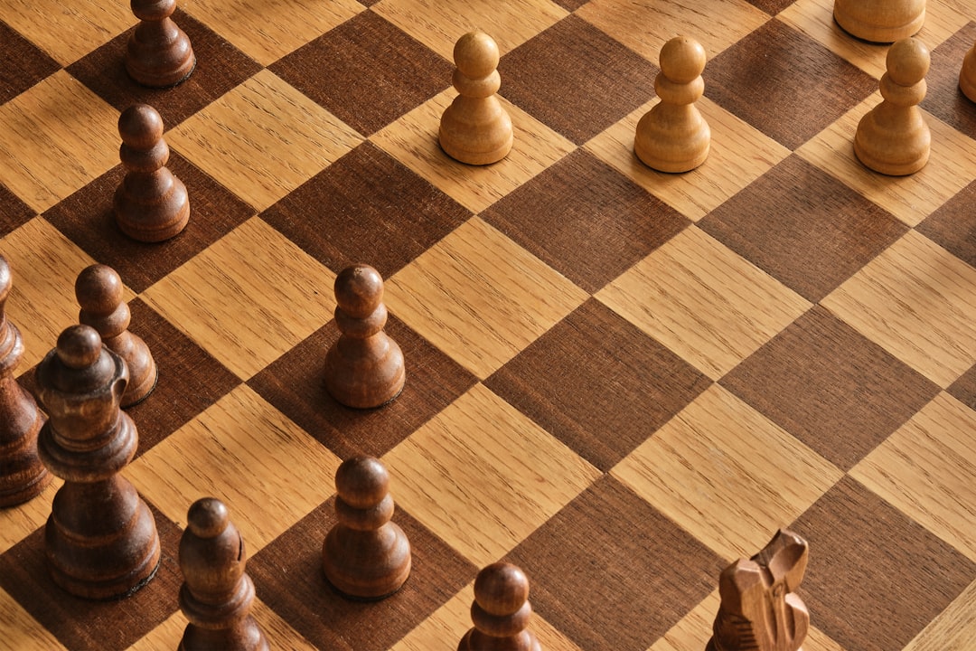 Brown chess pieces on brown wooden chess board