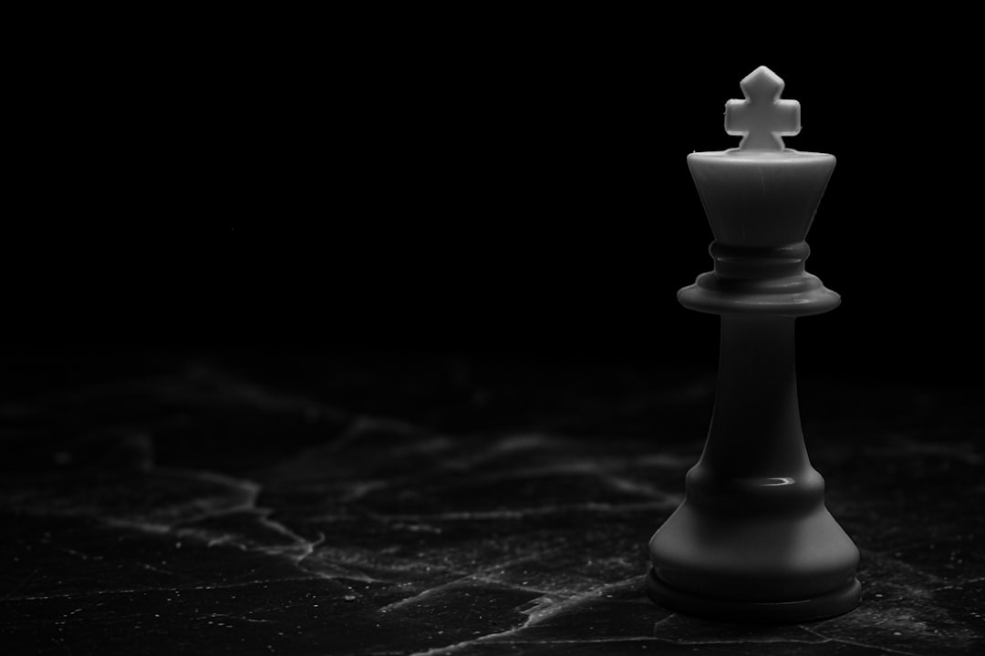 White chess piece on black surface