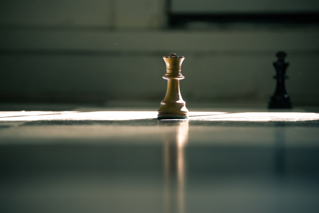 White queen chess piece on white surface