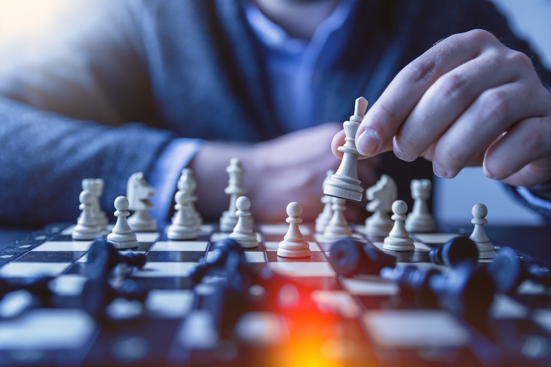 Depth of field photography of man playing chess