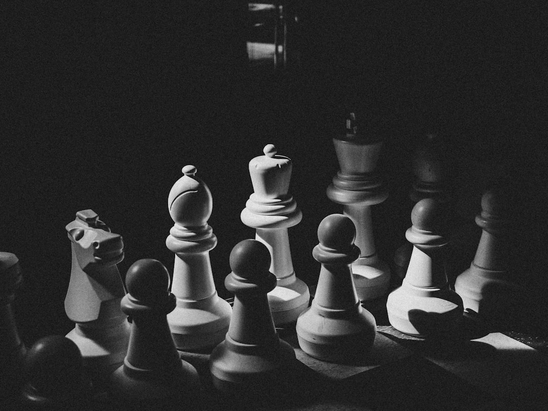 A black and white photo of chess pieces