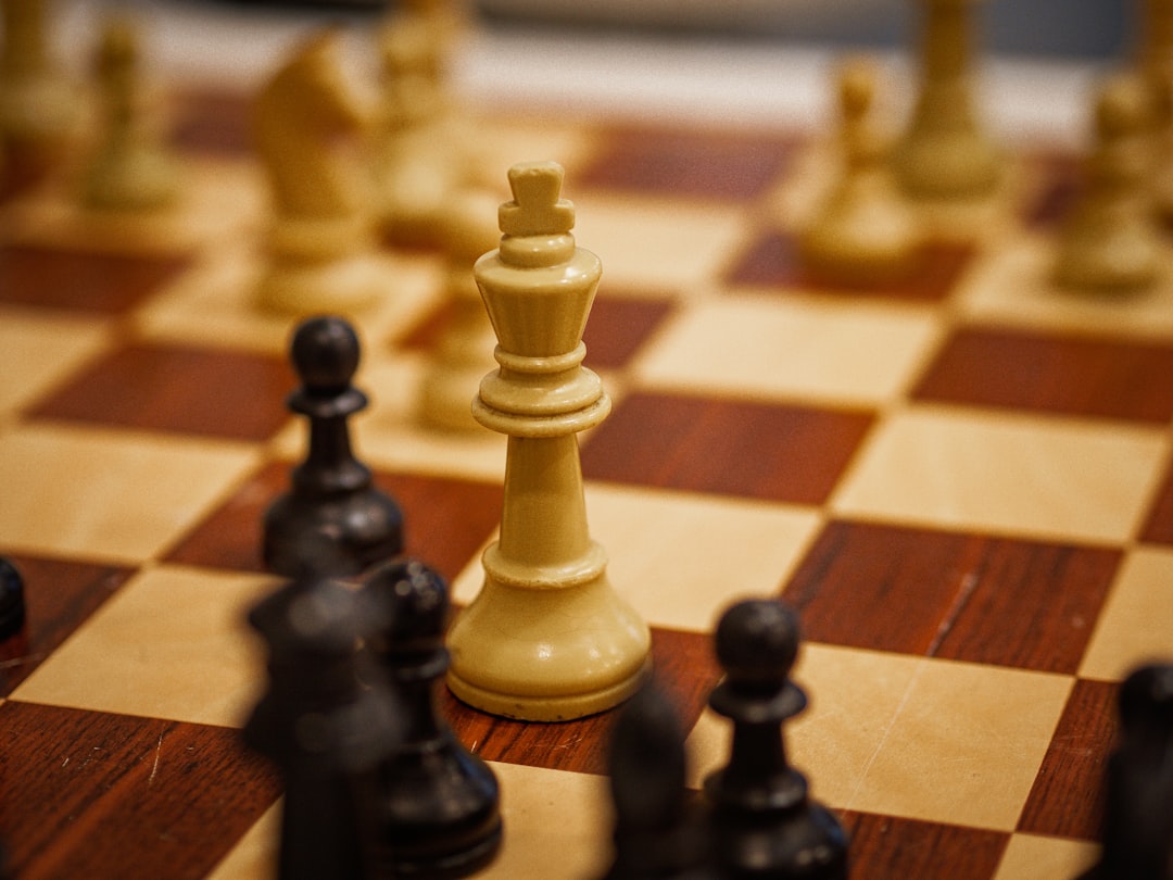 A close up of a chess board with pieces on it